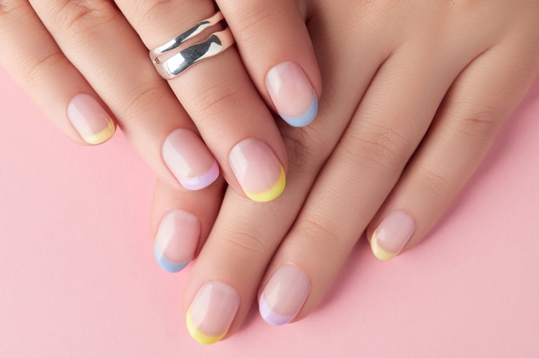 Close up manicured woman's hands on pink background with spring summer nail design