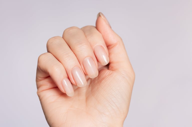 Beautiful delicate fashionable nude manicure on white background