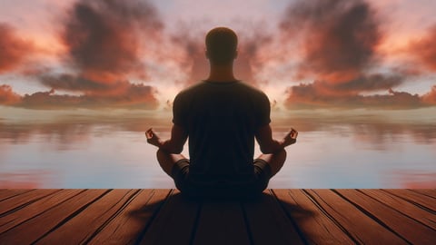 Person practicing meditation for mental wellness and calm