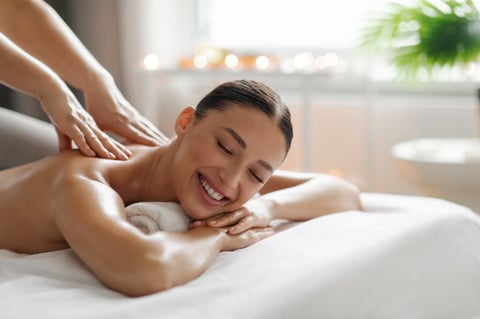 Happy woman enjoying spa massage treatment