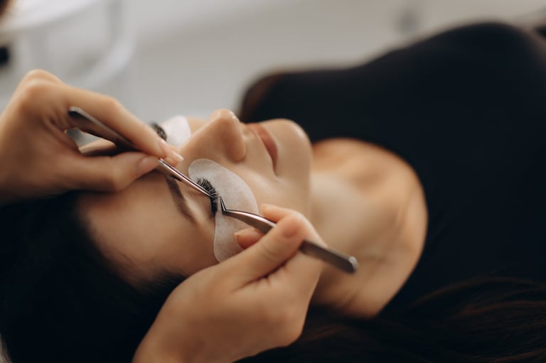 Woman receiving professional lash extension treatment in a beauty salon